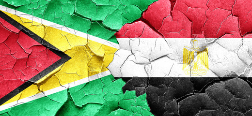 Guyana flag with egypt flag on a grunge cracked wall