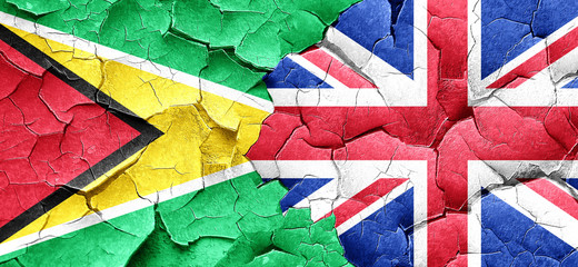 Guyana flag with Great Britain flag on a grunge cracked wall