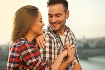 young couple in sunset loving each other, outdoors