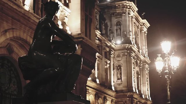 Woman statue at the hotel de ville in Paris at night