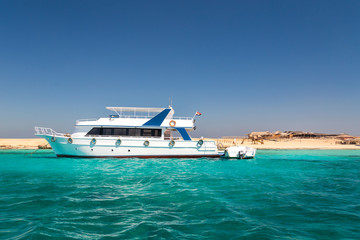 Small yacht docked in red sea.