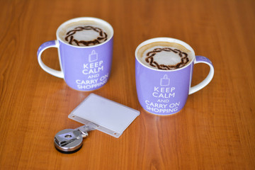 Two big cups of cappuccino, white milk coffee in the morning: keep calm and carry on shopping concept