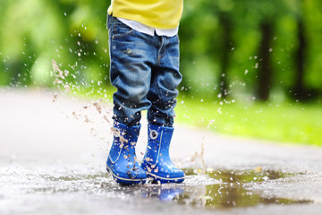 Toddler jumping in pool of water