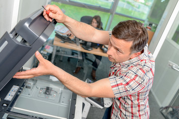 Man repairing photocopier