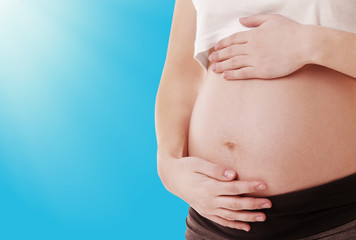 Fototapeta na wymiar Pregnant woman on light blue background