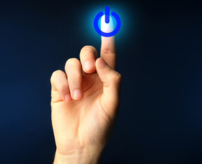 Finger press power button on virtual touch screen, modern technology concept