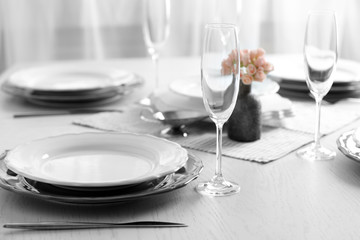 Table set at restaurant on light background