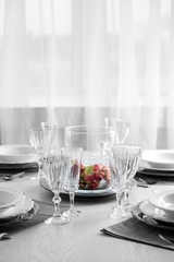 Table set at restaurant on light background