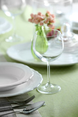 Table set at restaurant on light background