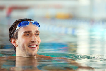 Head of handsome man in the swimming pool