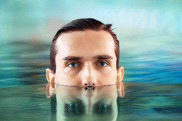 Young man swimming in pool