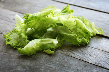 Fresh salad leaves on wooden background