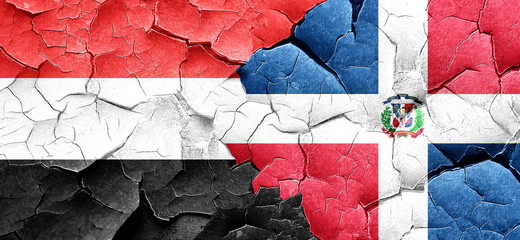 Yemen flag with Dominican Republic flag on a grunge cracked wall