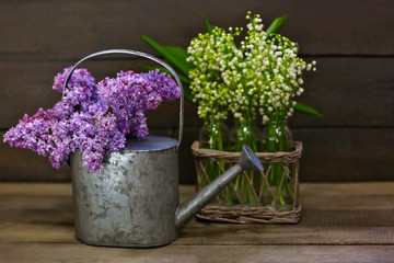 Bouquets of spring flowers on wooden background