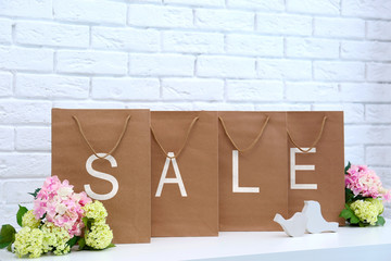 Recycled paper shopping bags on brick wall background