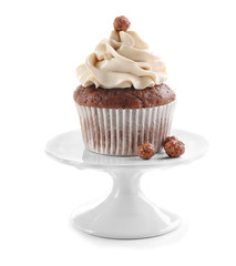Tasty chocolate cupcake on stand, isolated on white