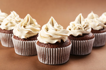 Tasty cupcakes on color background
