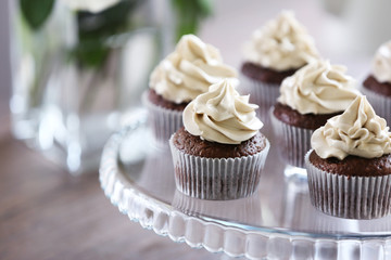 Tasty cupcakes on glass stand