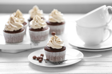 Tasty cupcakes on wooden table