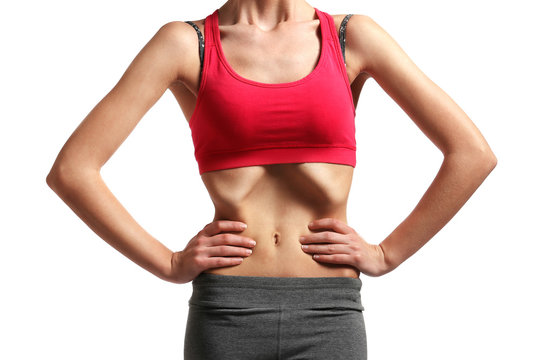 Belly of young woman with anorexia on white background