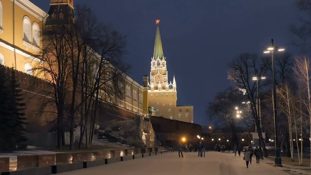 people are walking near a wall of Moscow Kremlin in twilight city