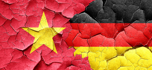 Vietnam flag with Germany flag on a grunge cracked wall