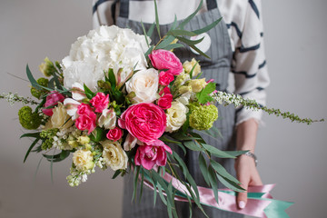 Rich bunch of flowers, green leaf in hand Fresh spring bouquet. Summer Background.