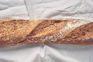 baguette bread on white table cloth - closeup - top view