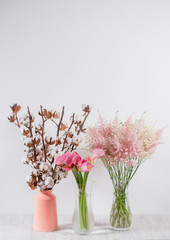 cotton flowers in a vase on  wooden background