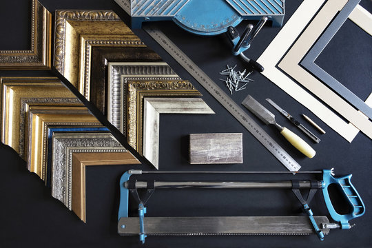 Overhead view of picture frame samples and work tools on table