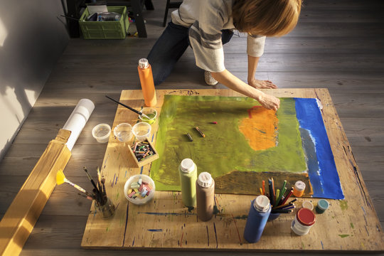 High Angle View Of Woman Painting On Canvas At Home