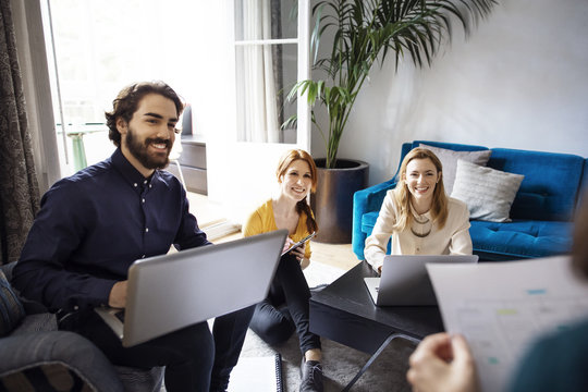 Happy Business People Using A Laptop During Meeting In Office