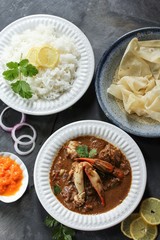 Crab curry served with rice and Rumali roti