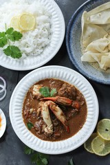 Crab curry served with rice and Rumali roti