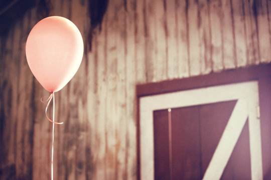 Low angle view of balloon against wooden wall