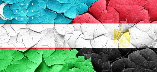 Uzbekistan flag with egypt flag on a grunge cracked wall