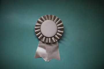 Close-up of award ribbon against green background