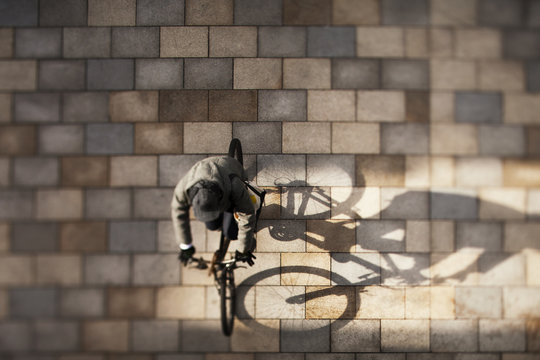 Overhead view of man riding bicycle on street