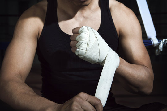 Midsection of boxer wearing hand wrap