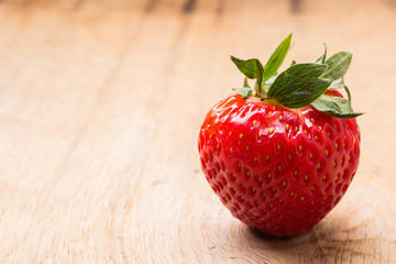 Red fresh strawberry fruit on wooden table.