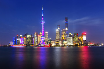 Scenic view of river and illuminated cityscape against sky