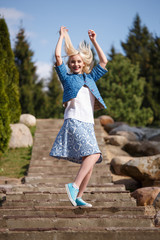 Portrait of beautiful girl posing in the Park fashion style skirt jacket