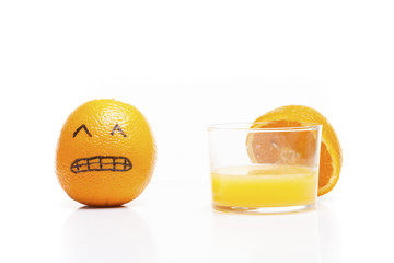 Stressed orange close to a glass of juice!. Funny moment.