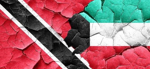 Trinidad and tobago flag with Kuwait flag on a grunge cracked wa