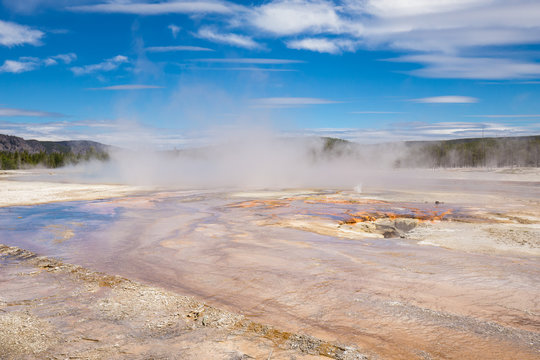 Beautiful cinematic view of nature landscape in the American West under the blue cloudy sky. Geyser.