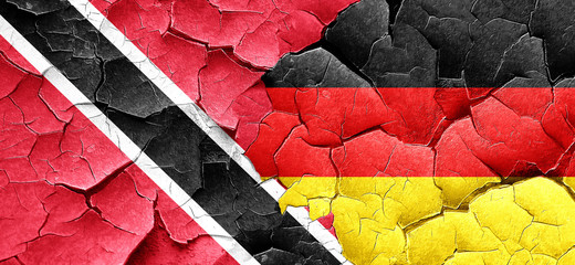 Trinidad and tobago flag with Germany flag on a grunge cracked w
