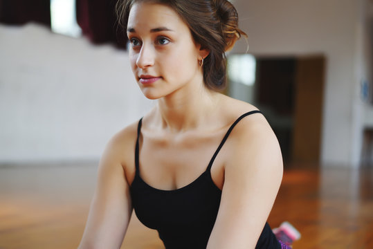 Athlete young woman doing exercise at gym. Indoors.