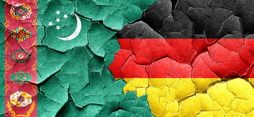 Turkmenistan flag with Germany flag on a grunge cracked wall