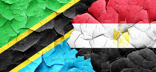 Tanzanian flag with egypt flag on a grunge cracked wall