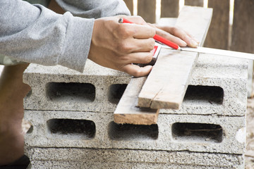 Male carpenter working with wood pencil at work place.Background craftsman tool.Zoom in